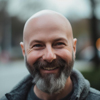 Image of a bald man with a beard smiling
